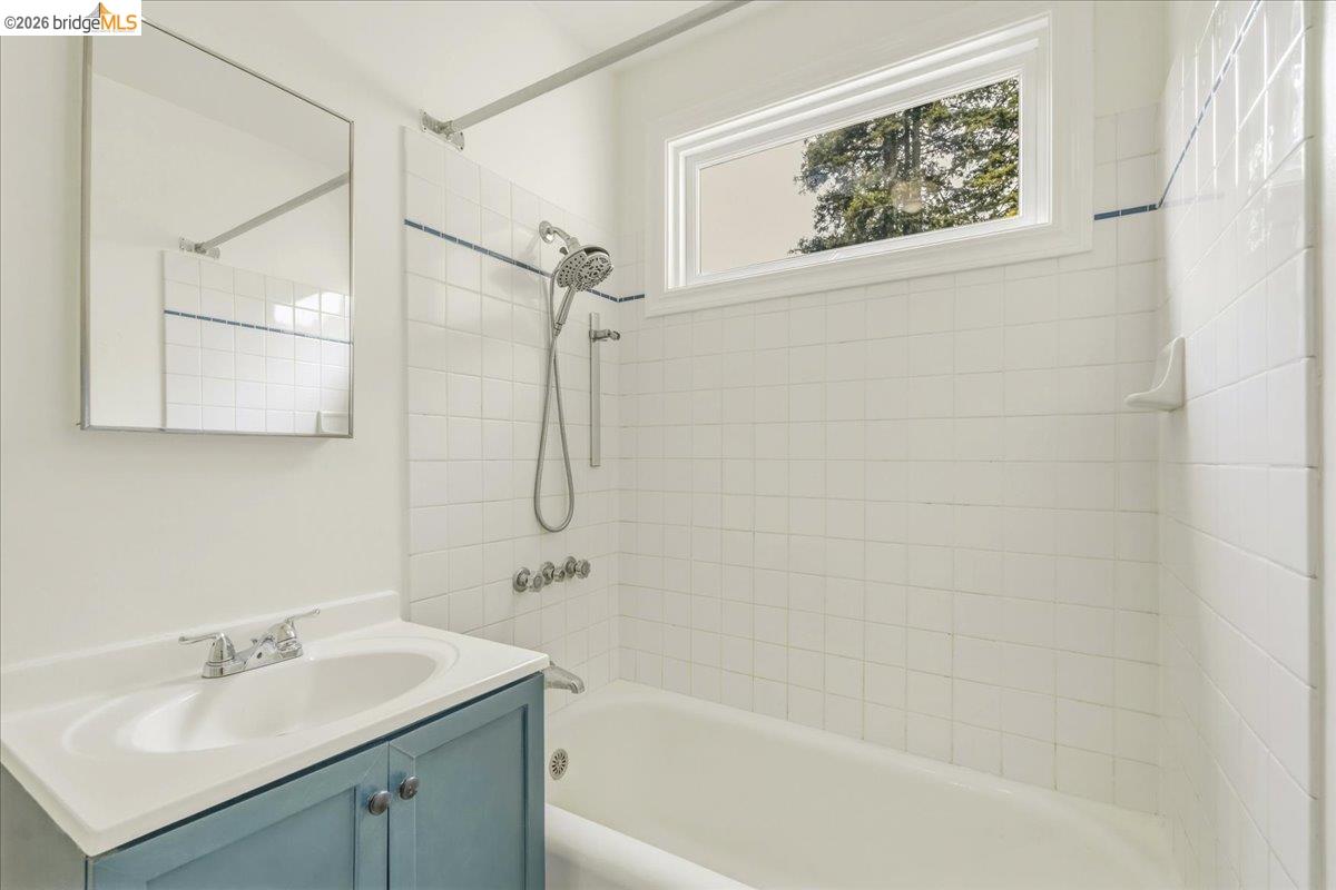 2403 Cedar Street Berkeley, CA 94708 - Photo 30 of 33 Bathroom featuring a light blue vanity with integrated sink, chrome faucet, and a large wall-mounted mirror