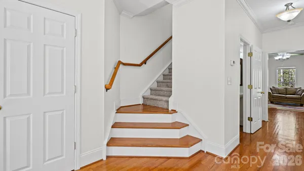 a view of entryway and hall with wooden floor