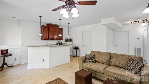 a living room with furniture a sink and a chandelier
