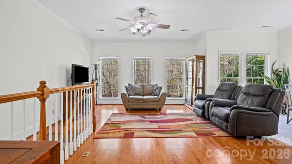 a living room with furniture fireplace and a large window
