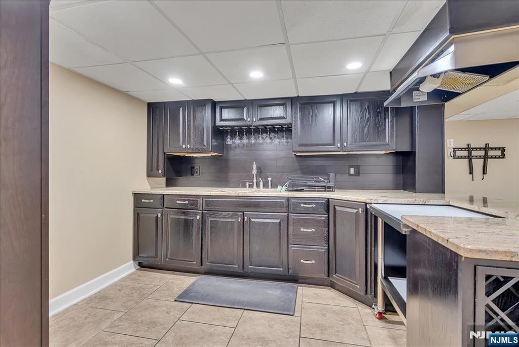 10 Irving Place Garfield, NJ 07026 - Photo 17 of 35 a kitchen with kitchen island granite countertop wooden cabinets a sink and appliances