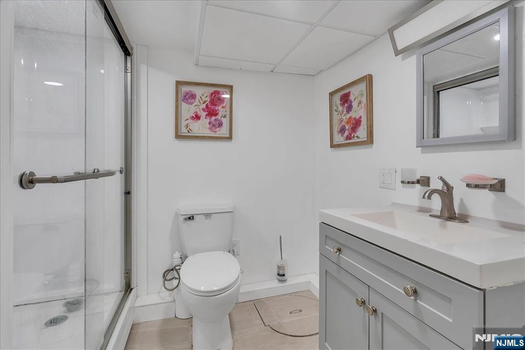 10 Irving Place Garfield, NJ 07026 - Photo 18 of 35 a bathroom with a toilet sink and mirror