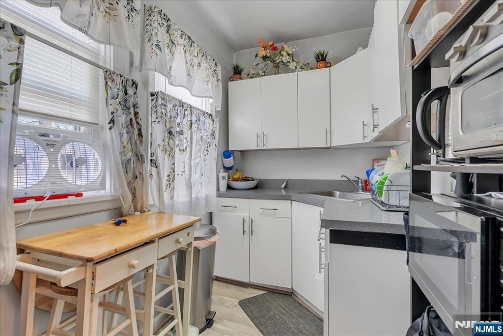 10 Irving Place Garfield, NJ 07026 - Photo 26 of 35 a kitchen with stainless steel appliances a stove a sink and a refrigerator