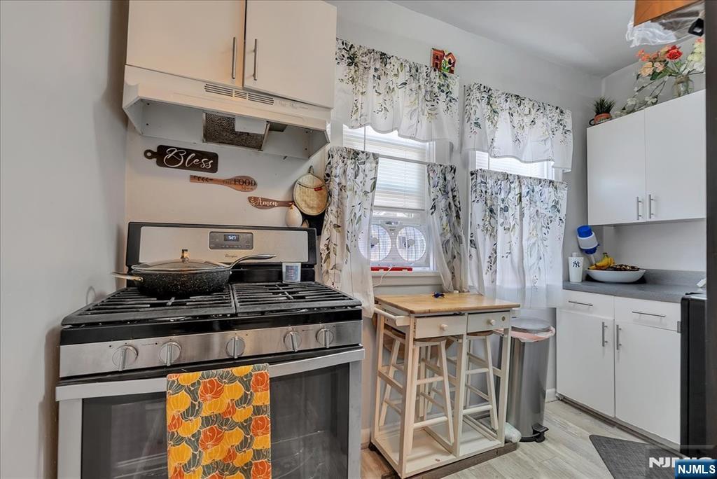 10 Irving Place Garfield, NJ 07026 - Photo 27 of 35 a kitchen with stainless steel appliances granite countertop a stove and a cabinets