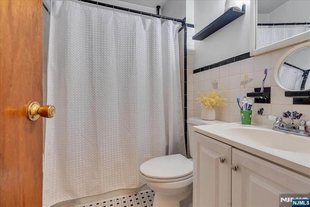 10 Irving Place Garfield, NJ 07026 - Photo 28 of 35 a bathroom with a sink toilet and shower