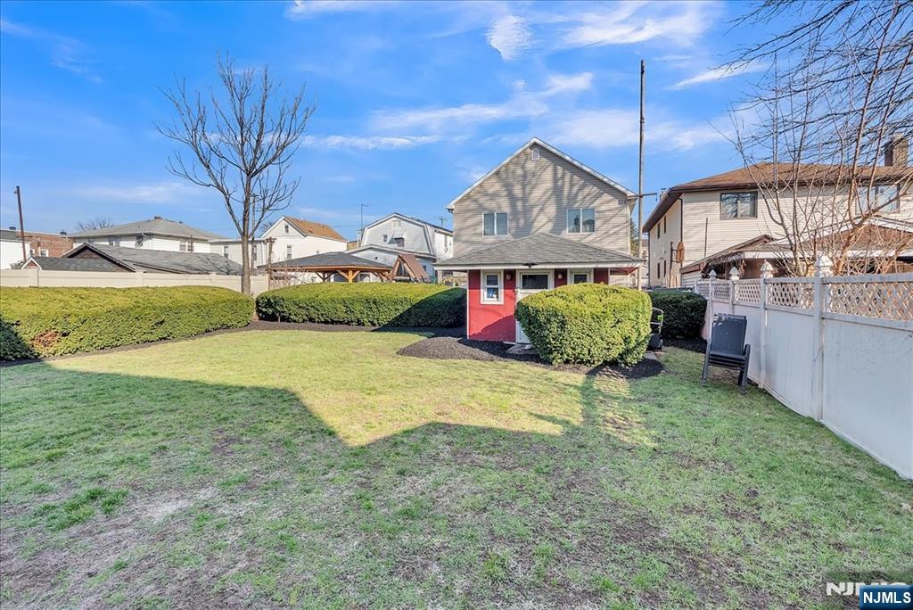 10 Irving Place Garfield, NJ 07026 - Photo 5 of 35 a yellow house with a yard