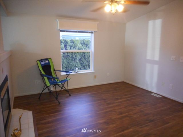 a workspace with wooden floor and a window