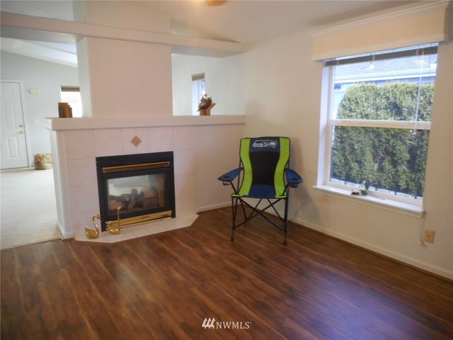 a living room with a fireplace and a table