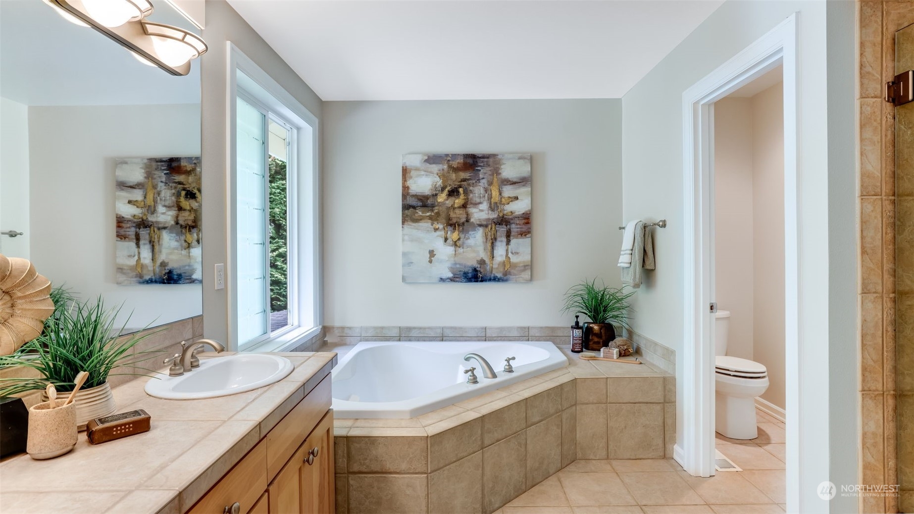 20622 Southeast 162nd Way Renton, WA 98059 - Photo 15 of 27 a bath tub sitting in a bathroom next to a sink