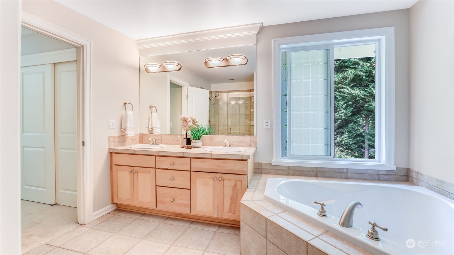 20622 Southeast 162nd Way Renton, WA 98059 - Photo 17 of 27 a bathroom with a bathtub a sink a mirror a vanity and window