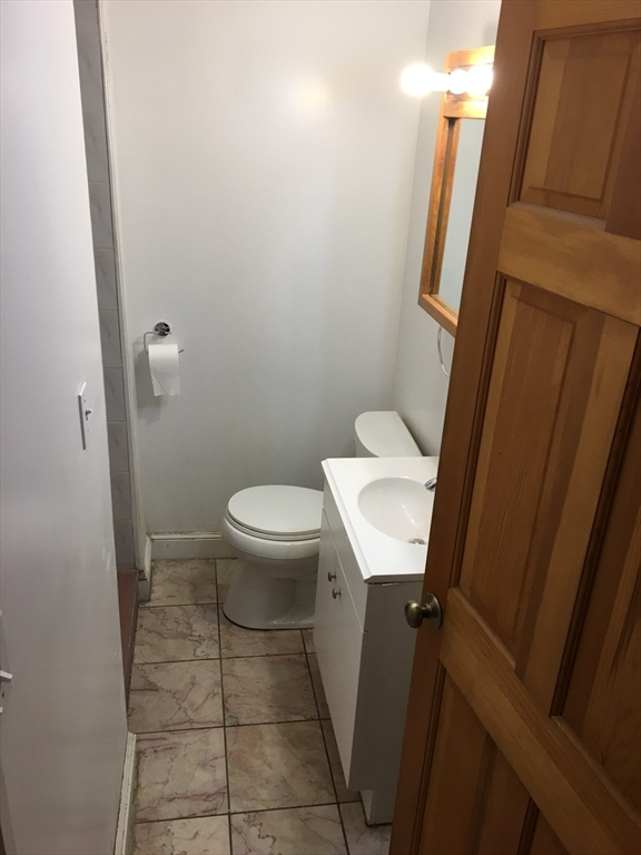 391 Langley Road, Unit 2 Newton, MA 02459 - Photo 11 of 12 a bathroom with a sink a toilet and a mirror