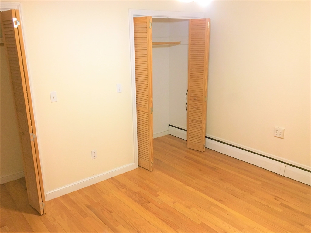 391 Langley Road, Unit 2 Newton, MA 02459 - Photo 6 of 12 a view of an empty room