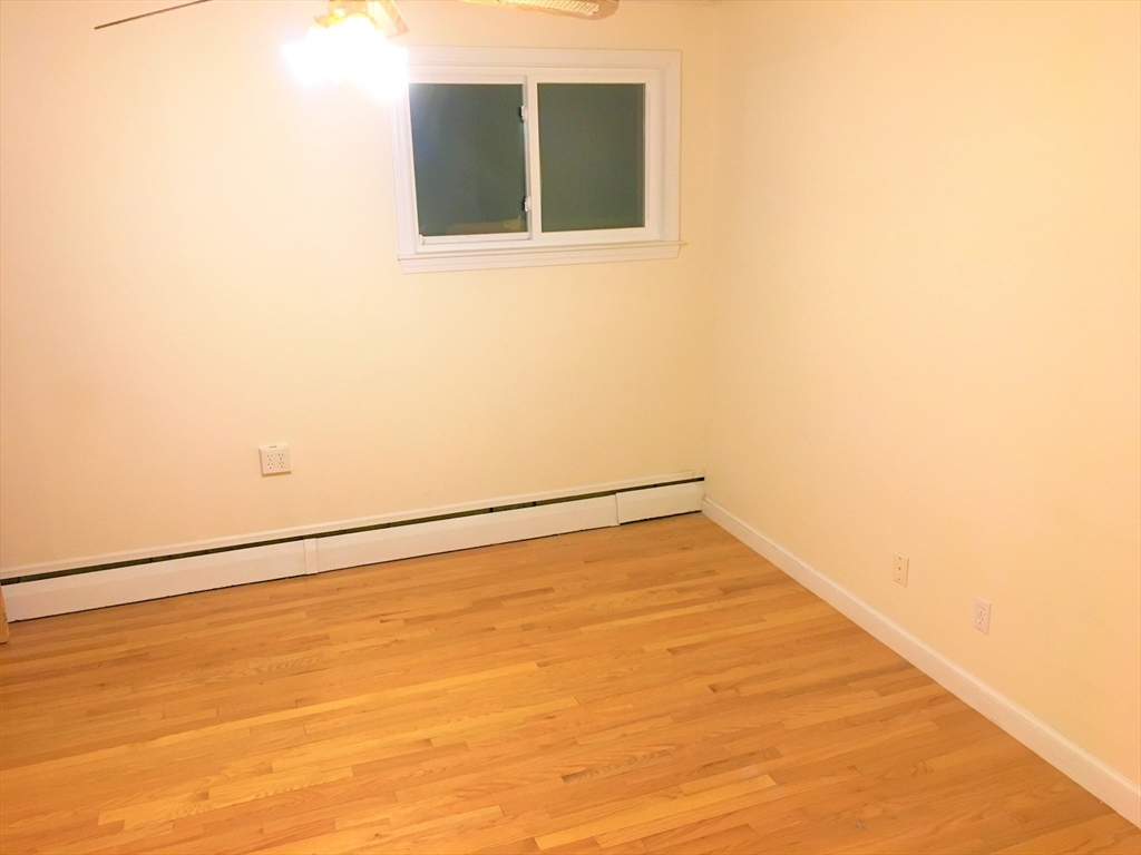 391 Langley Road, Unit 2 Newton, MA 02459 - Photo 7 of 12 a view of an empty room