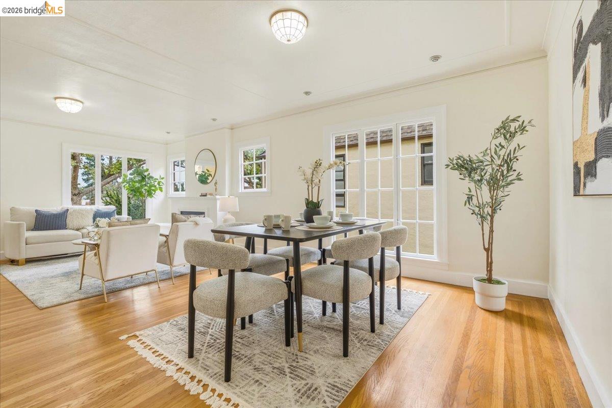 2403 Cedar Street Berkeley, CA 94708 - Photo 7 of 33 Expansive living and dining areas featuring warm wood-finish flooring, white trim, and multiple large windows