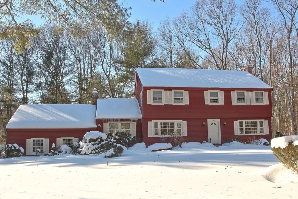 73 Austin Road Sudbury, MA 01776 - Photo 25 of 26 a view of a brick house with many windows next to a road