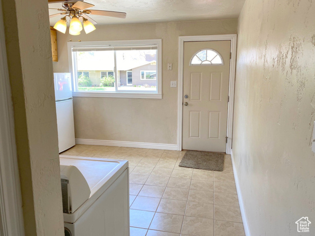 247 West 400 North, Unit 1 Moab, UT 84532 - Photo 11 of 27 Foyer entrance with light tile patterned floors, plenty of natural light, washer / clothes dryer, ceiling fan, and a textured wall