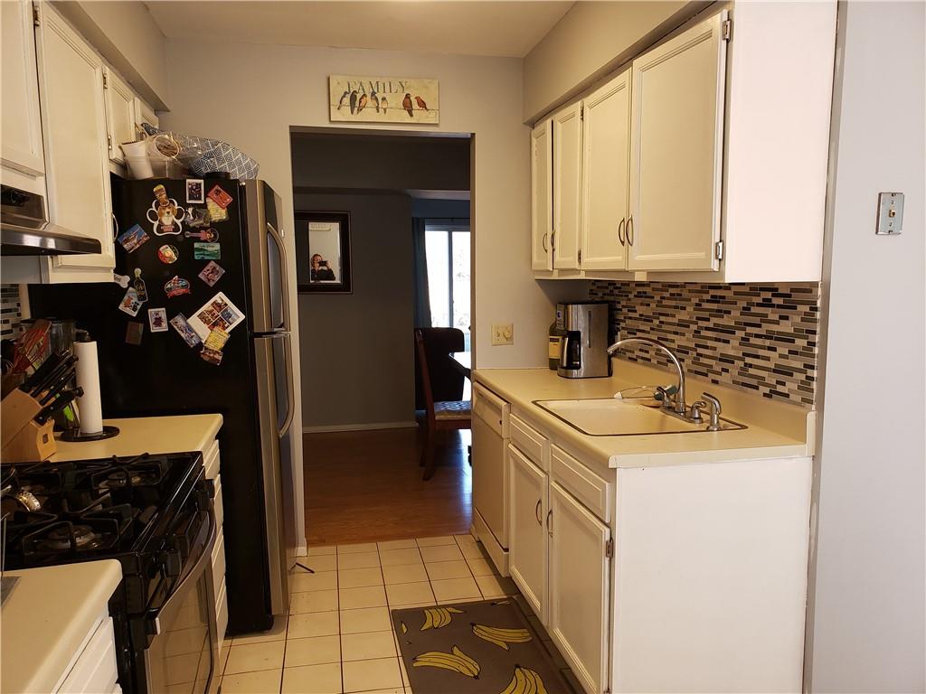 276 Temple Hill Road, Unit 707 New Windsor, NY 12553 - Photo 1 of 1 a kitchen with a sink stove and cabinets