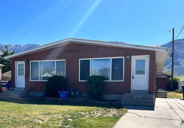 824 750 West Provo, UT 84604 - Photo 1 of 1 View of front facade featuring entry steps, a mountain view, a front lawn, and brick siding
