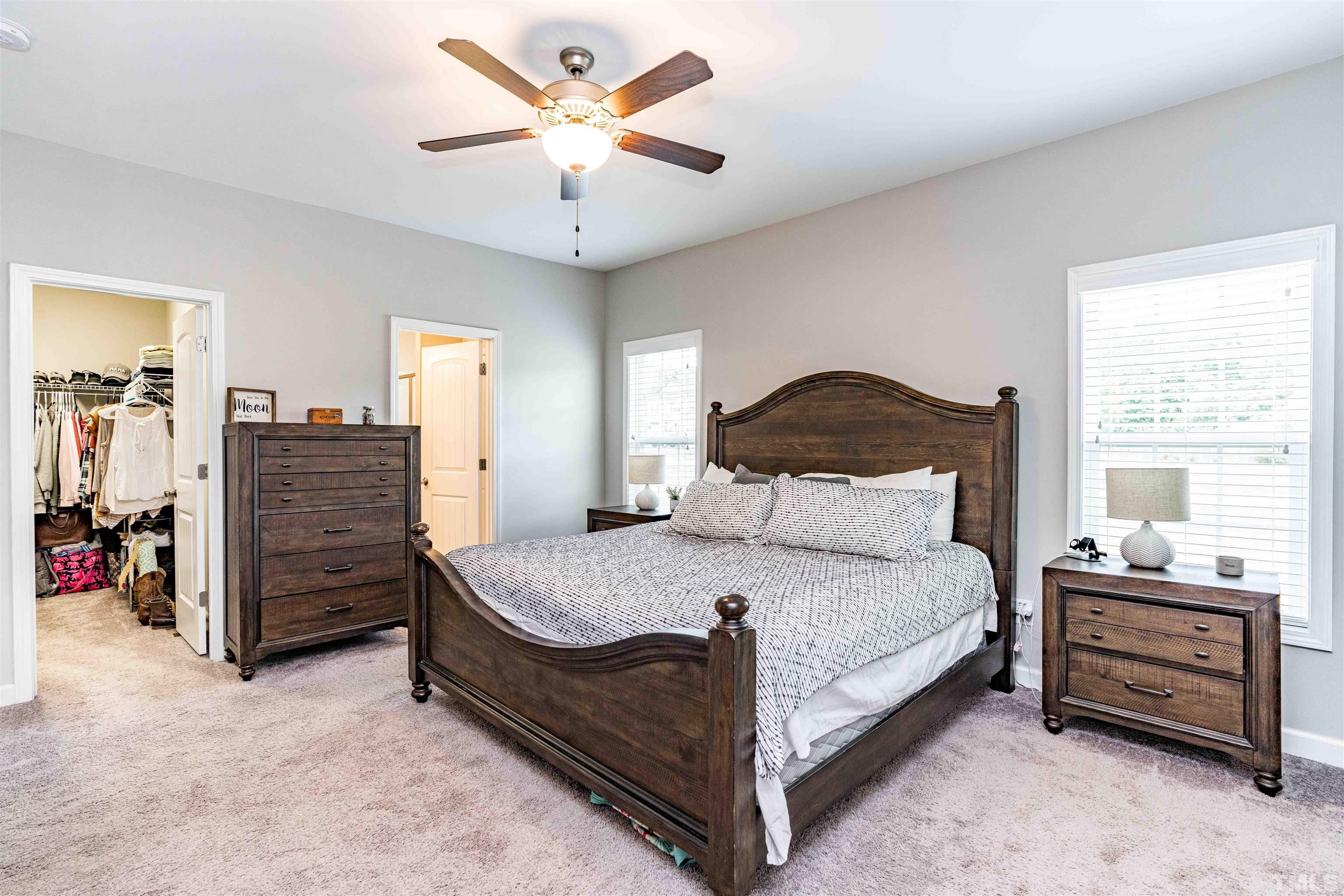 11565 Barnes Road Middlesex, NC 27557 - Photo 12 of 25 a bedroom with a bed and a chandelier