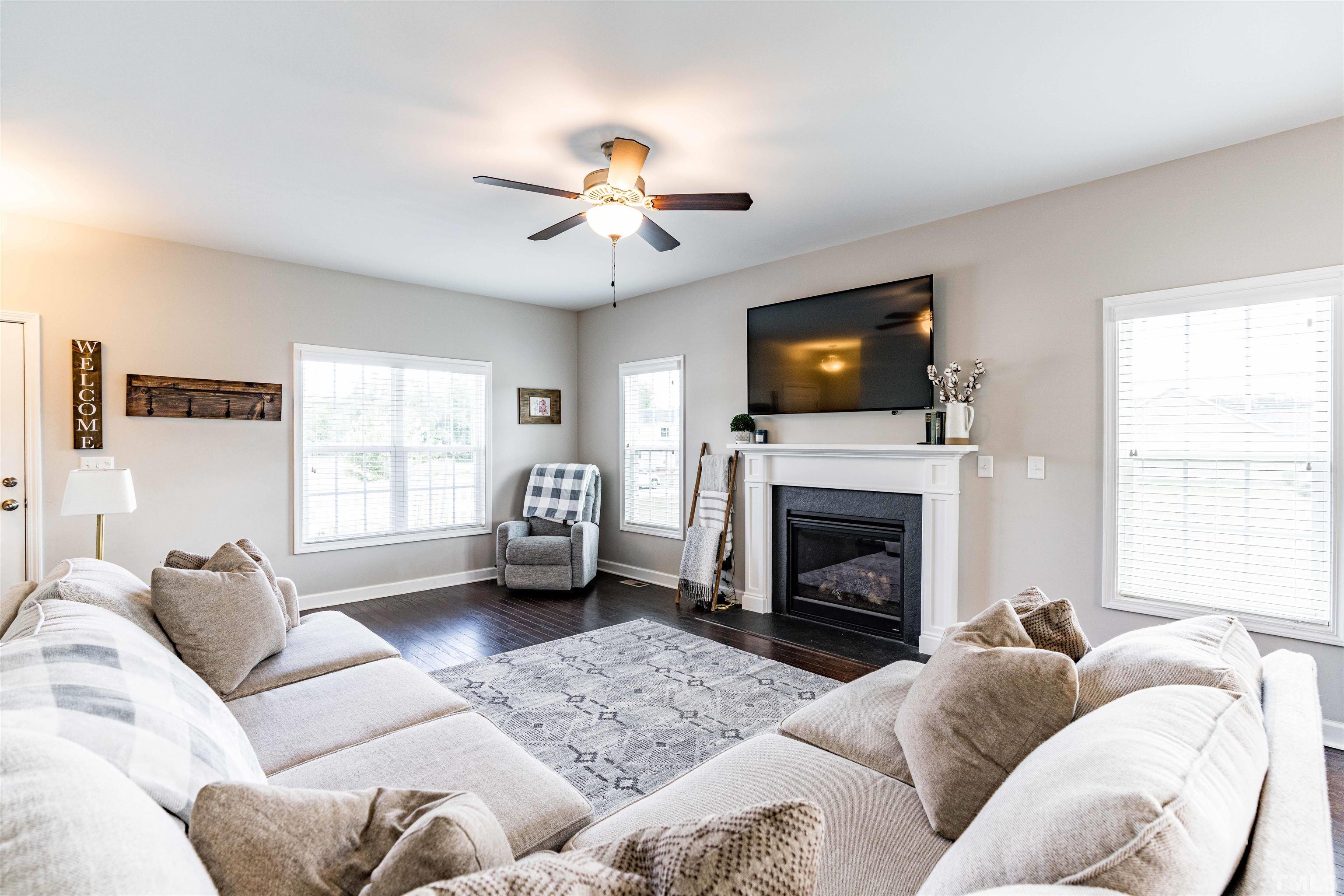 11565 Barnes Road Middlesex, NC 27557 - Photo 4 of 25 a living room with furniture a fireplace and a flat screen tv