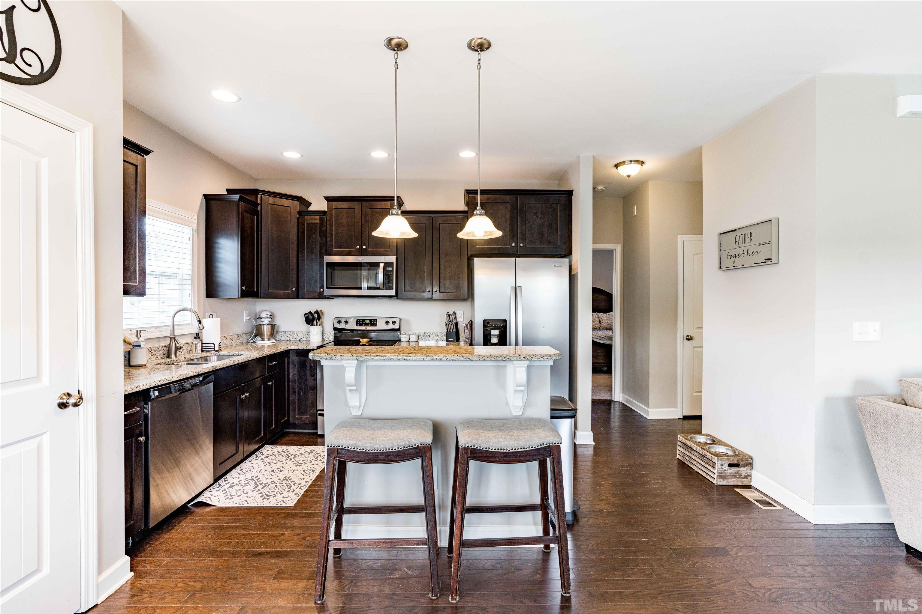 11565 Barnes Road Middlesex, NC 27557 - Photo 8 of 25 a large kitchen with cabinets chairs and refrigerator