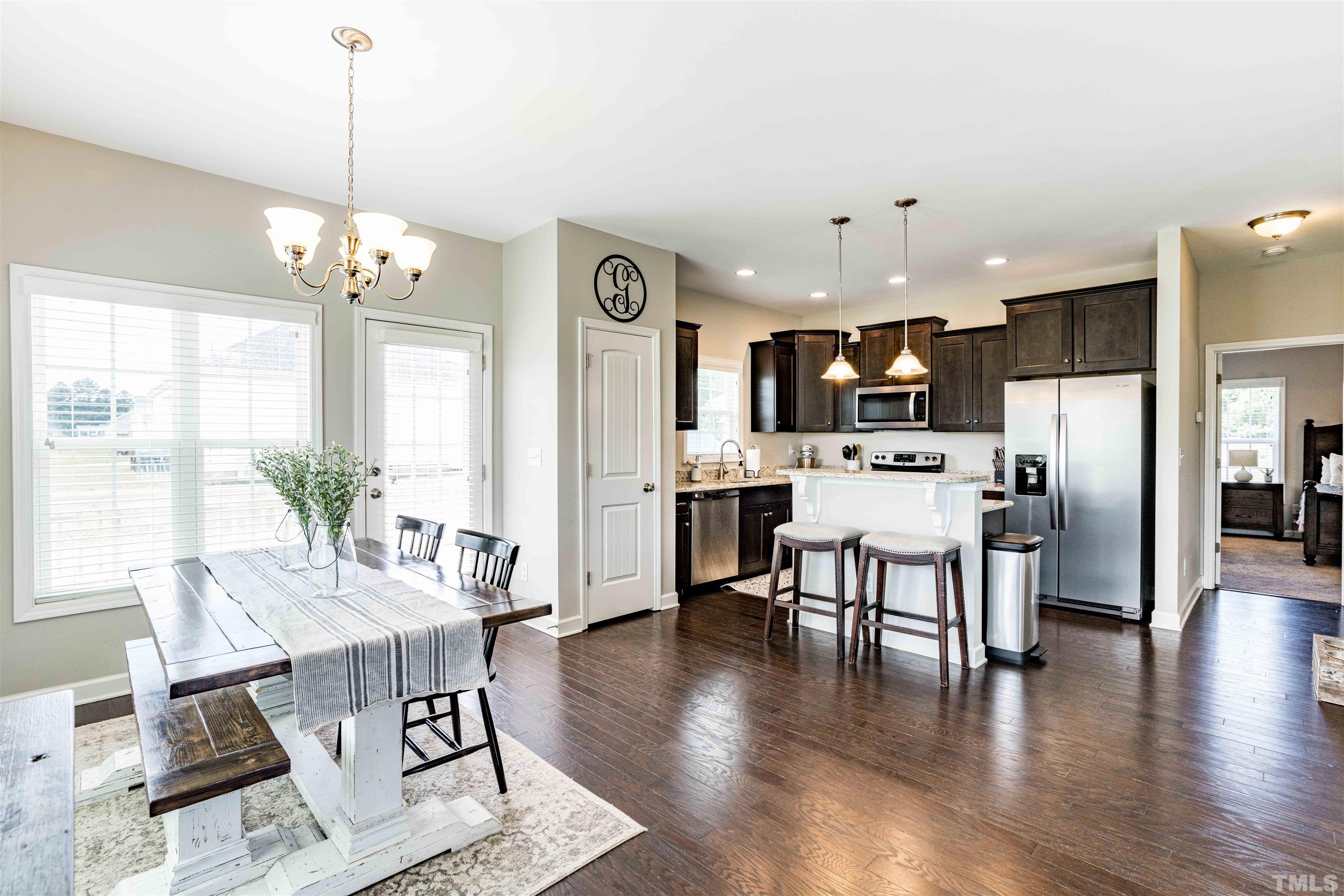 11565 Barnes Road Middlesex, NC 27557 - Photo 9 of 25 a view of a dining room and livingroom with furniture wooden floor a chandelier