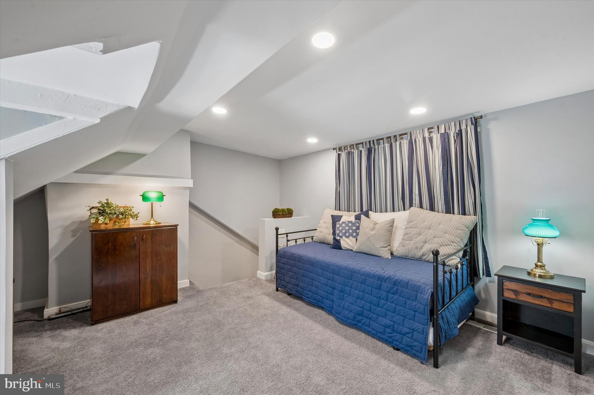 4509 Ritchie Street Philadelphia, PA 19127 - Photo 12 of 16 a bedroom with a bed and a chandelier