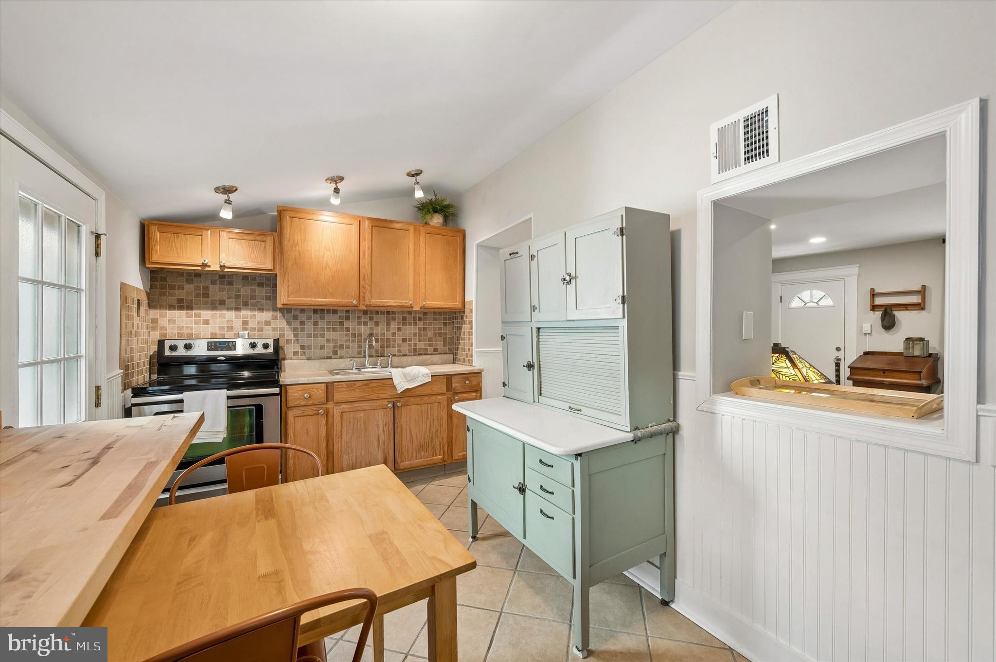 4509 Ritchie Street Philadelphia, PA 19127 - Photo 8 of 16 a kitchen with stainless steel appliances granite countertop a sink a stove a refrigerator cabinets and chairs