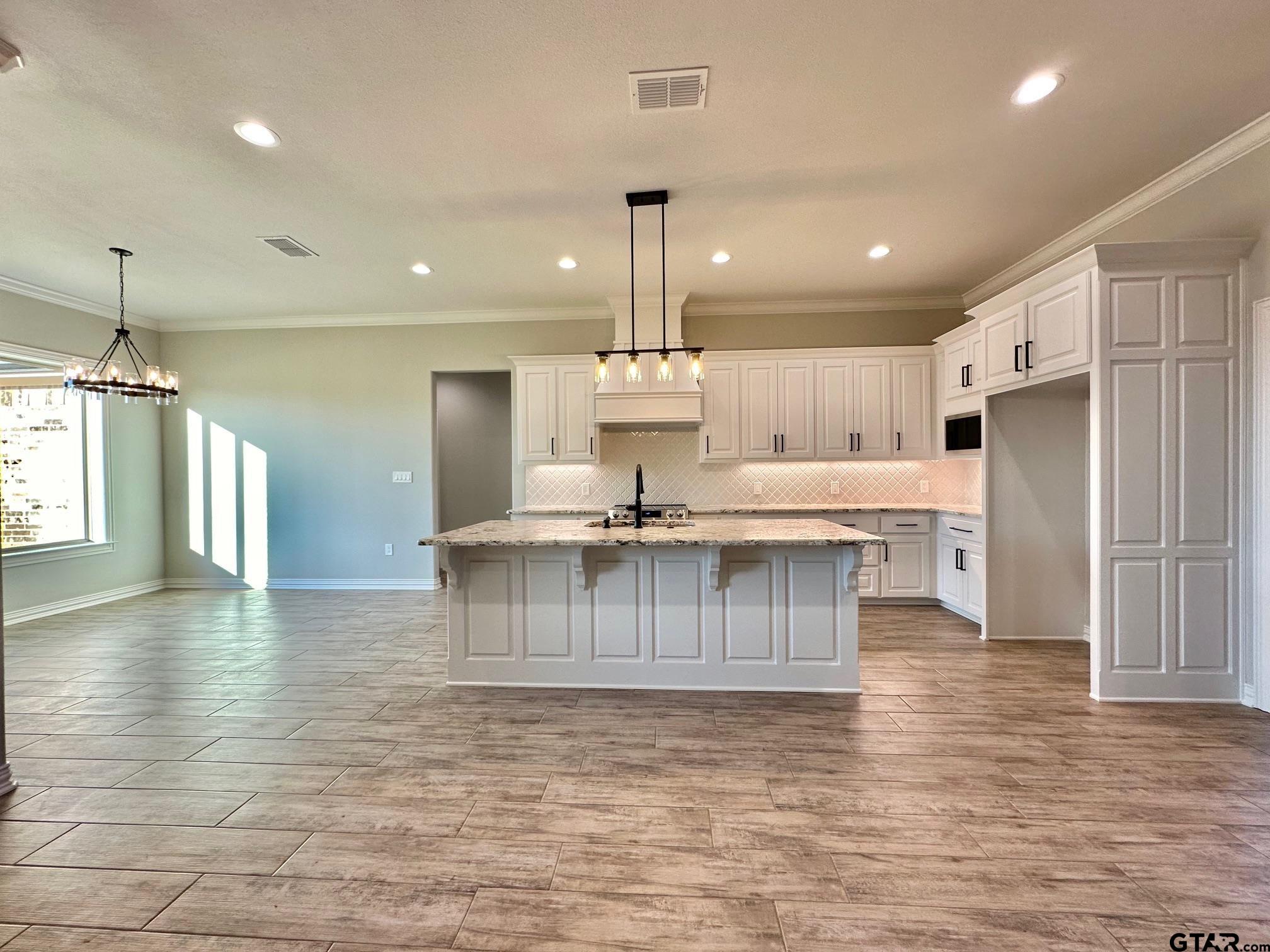 191 Brooks Drive Gladewater, TX 75647 - Photo 12 of 45 a large kitchen with stainless steel appliances kitchen island granite countertop a sink and cabinets