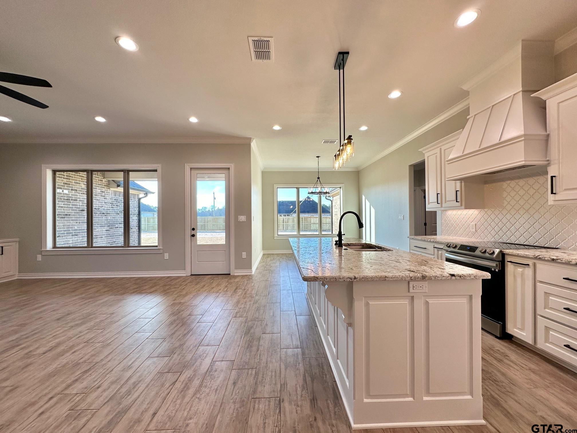 191 Brooks Drive Gladewater, TX 75647 - Photo 14 of 45 a large kitchen with stainless steel appliances granite countertop a stove and a wooden floors