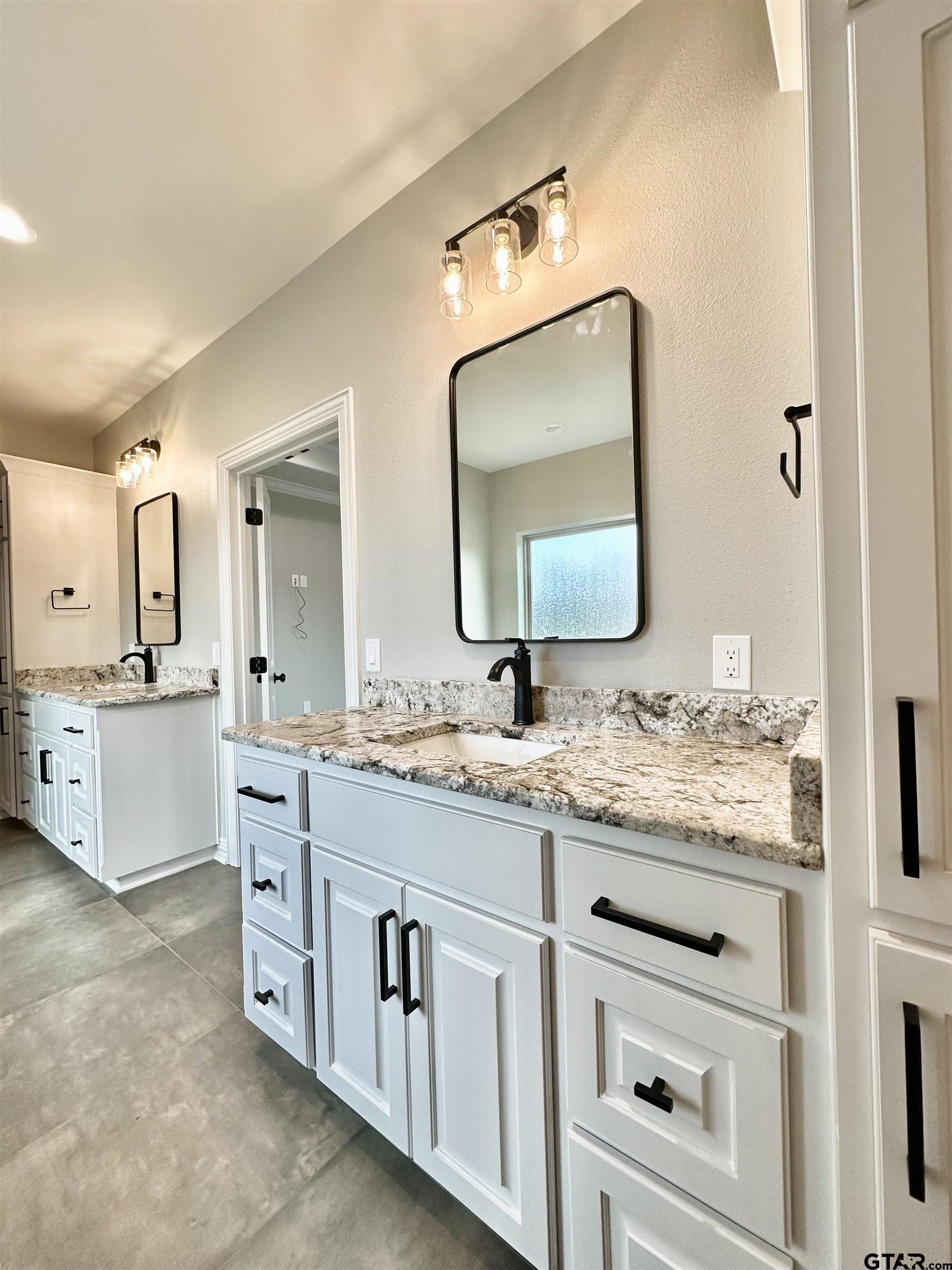 191 Brooks Drive Gladewater, TX 75647 - Photo 29 of 45 a bathroom with a granite countertop sink vanity and mirror
