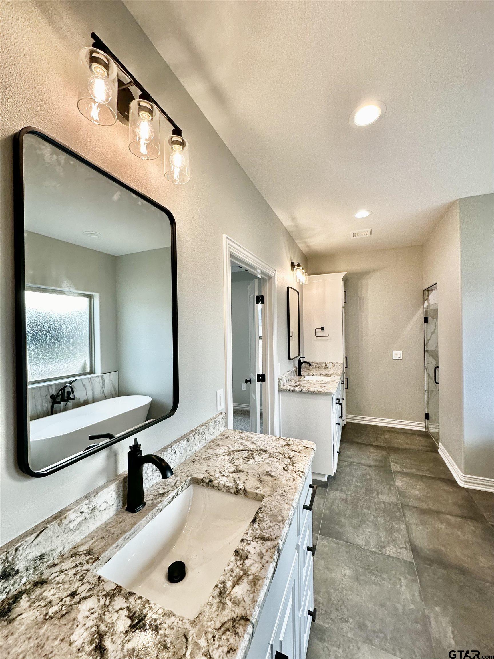 191 Brooks Drive Gladewater, TX 75647 - Photo 33 of 45 a bathroom with a sink a toilet and mirror