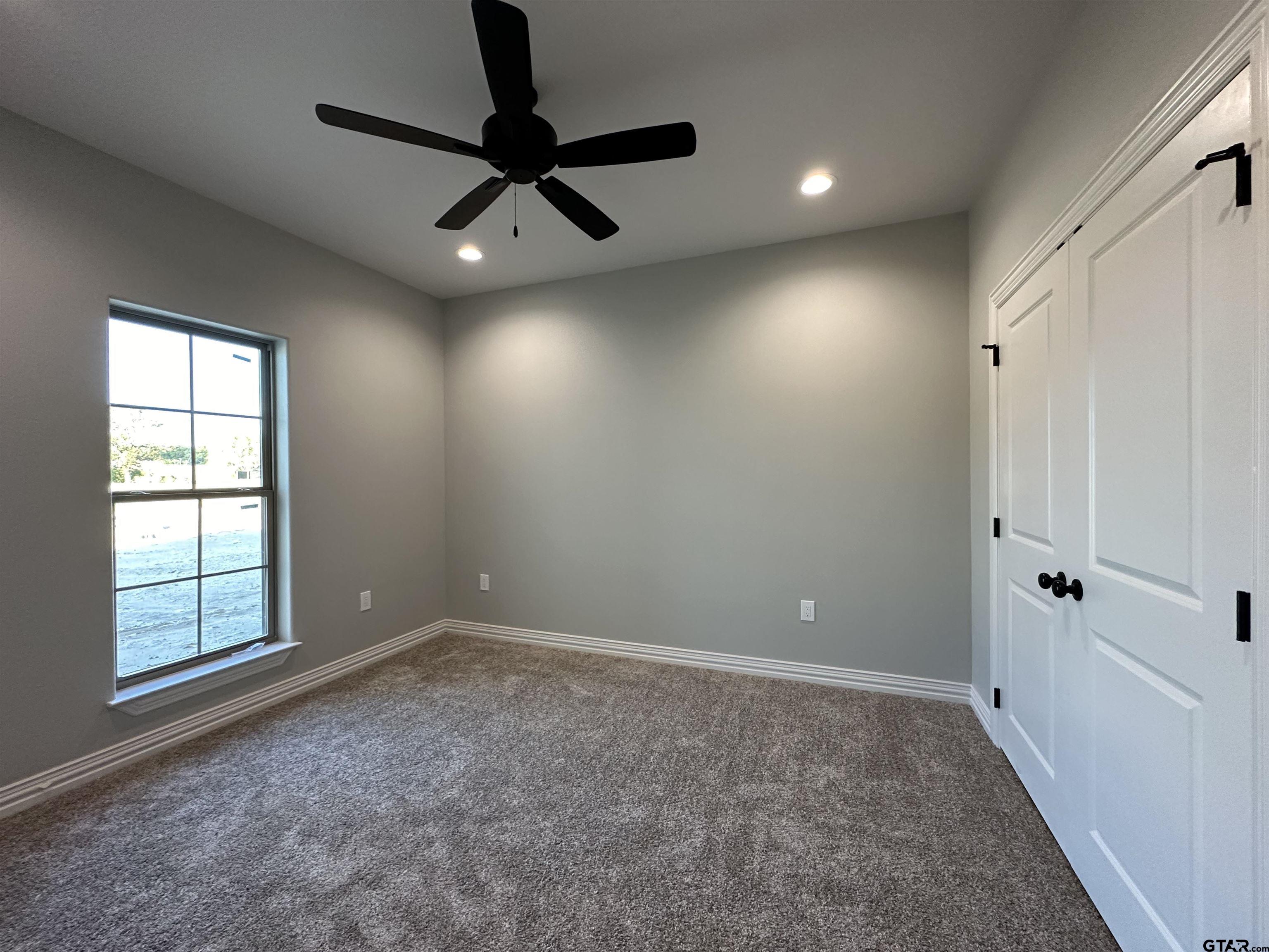 191 Brooks Drive Gladewater, TX 75647 - Photo 35 of 45 an empty room with windows and fan