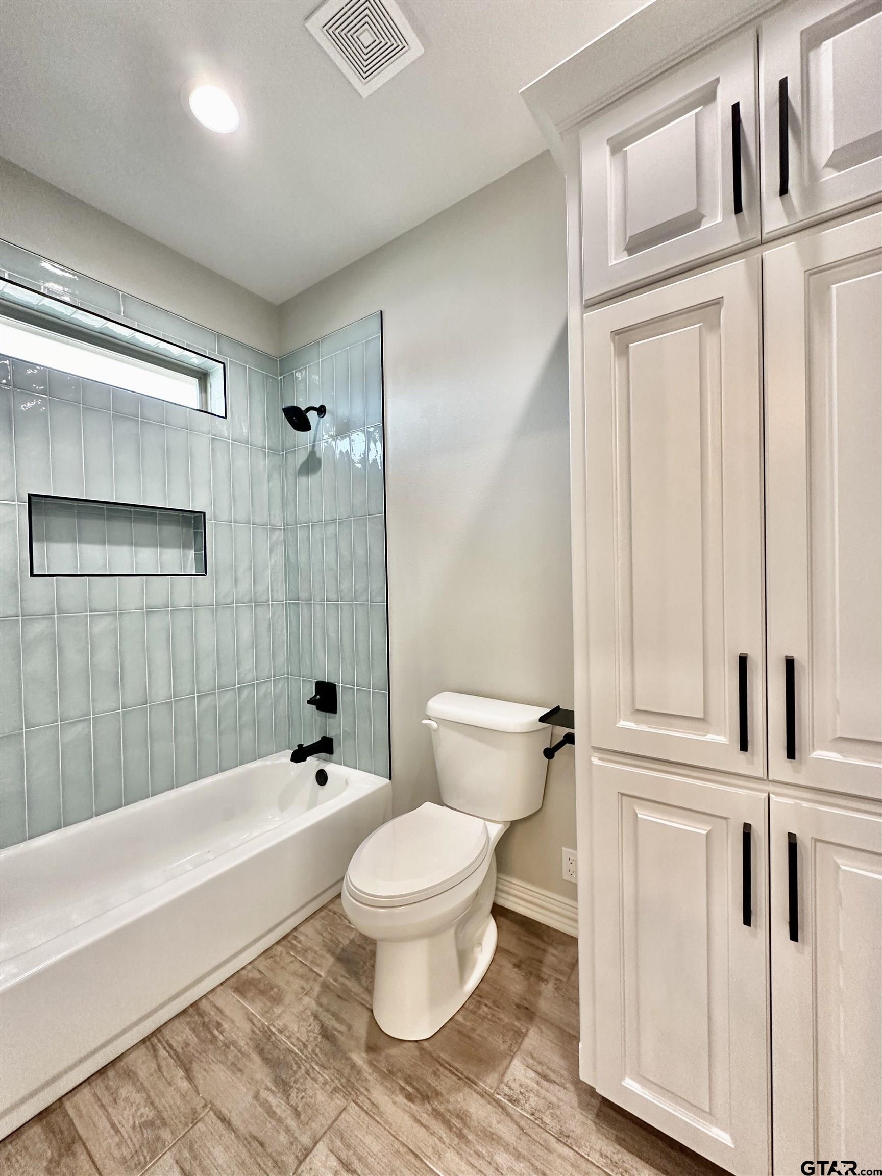 191 Brooks Drive Gladewater, TX 75647 - Photo 38 of 45 a bathroom with a toilet and a shower