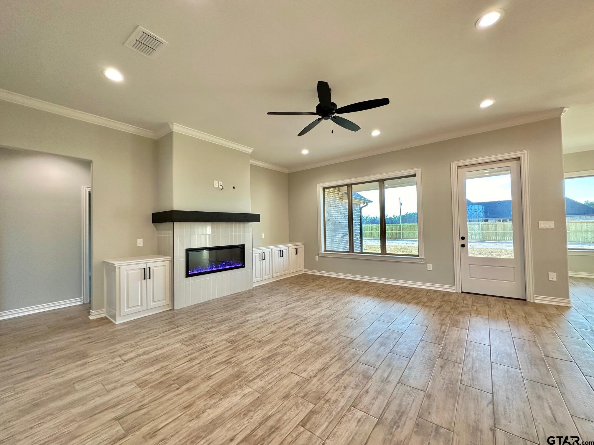 191 Brooks Drive Gladewater, TX 75647 - Photo 7 of 45 a view of empty room with wooden floor and fireplace