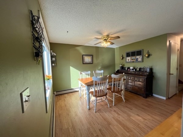 170 Ayer Road, Unit B2 Shirley, MA 01464 - Photo 4 of 28 a view of a dining room with furniture and wooden floor