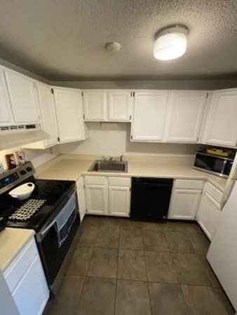 170 Ayer Road, Unit B2 Shirley, MA 01464 - Photo 7 of 28 a kitchen with a cabinets and white appliances