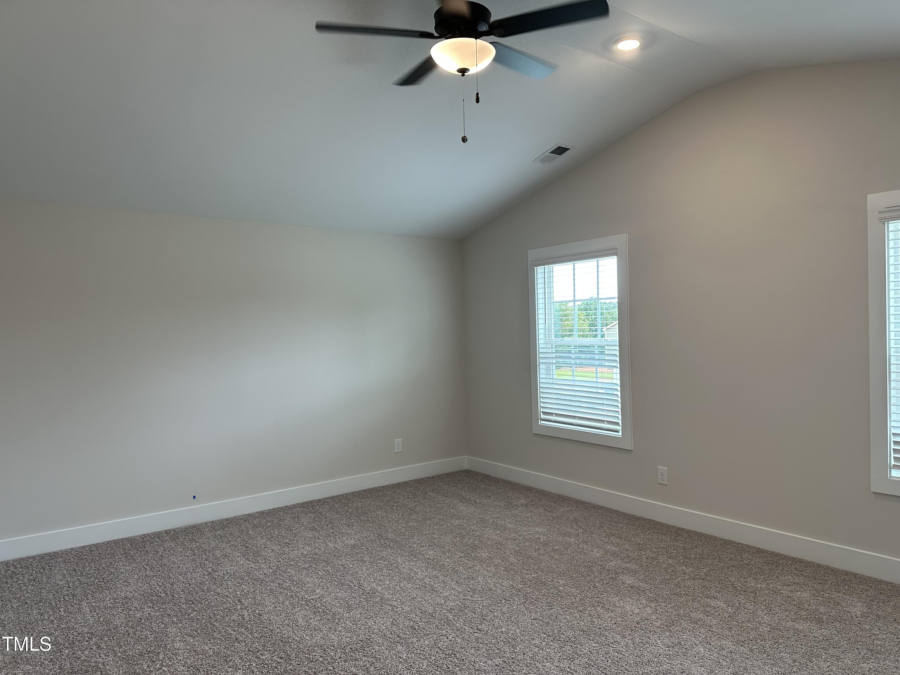 306 Shiloh Way Mebane, NC 27302 - Photo 14 of 33 an empty room with a window and a fan