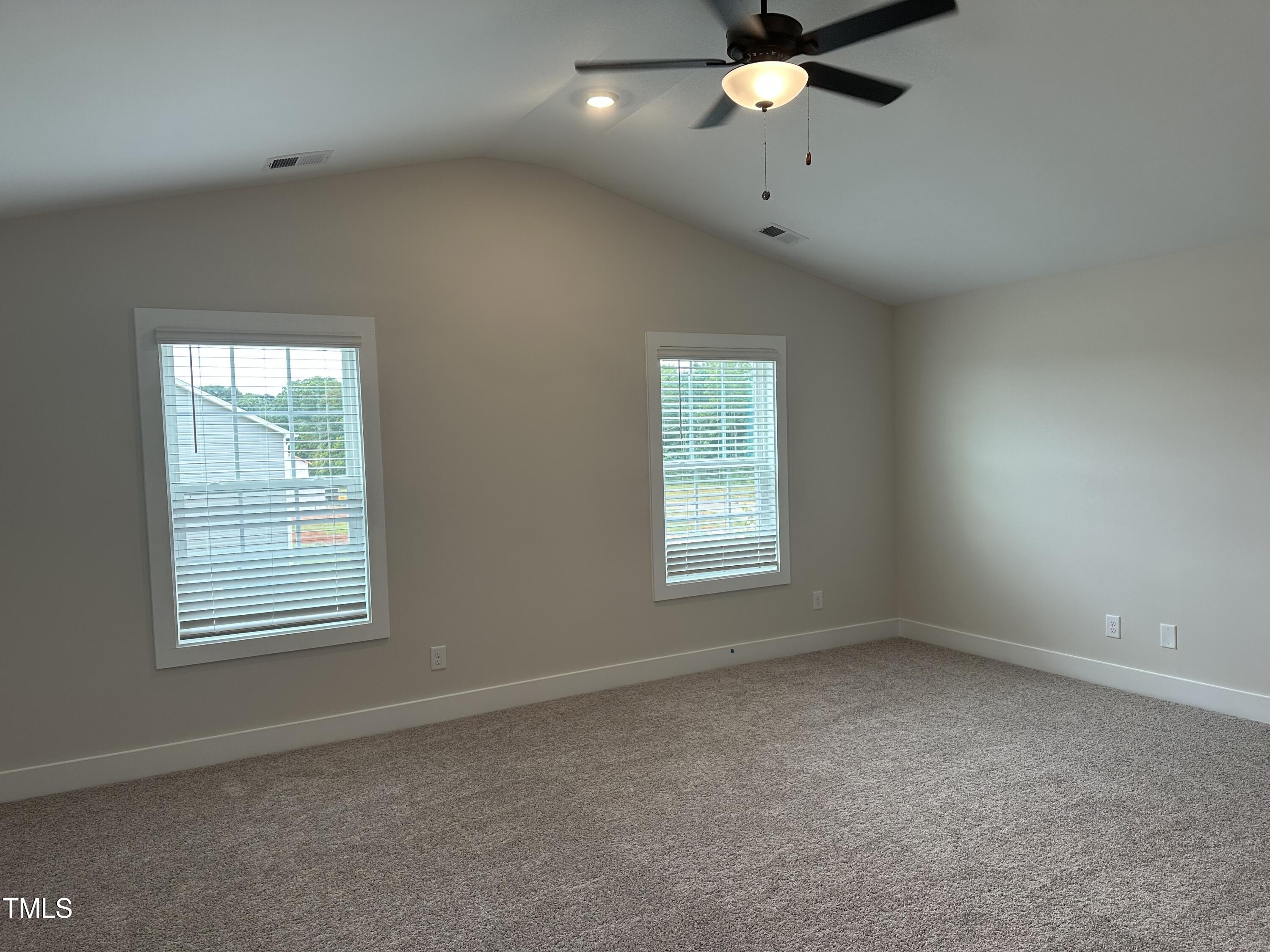 306 Shiloh Way Mebane, NC 27302 - Photo 15 of 33 an empty room with a window and a fan