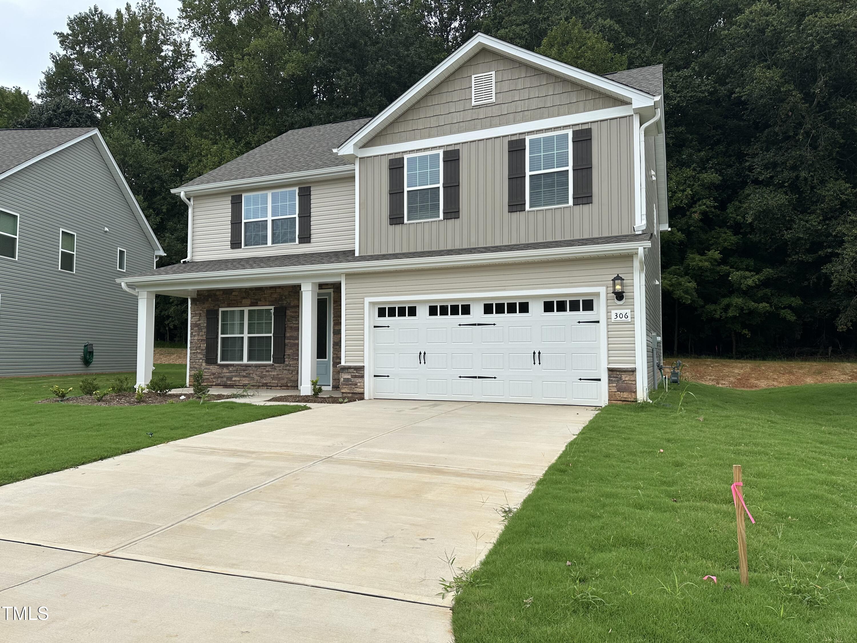 306 Shiloh Way Mebane, NC 27302 - Photo 2 of 33 a front view of a house with a yard