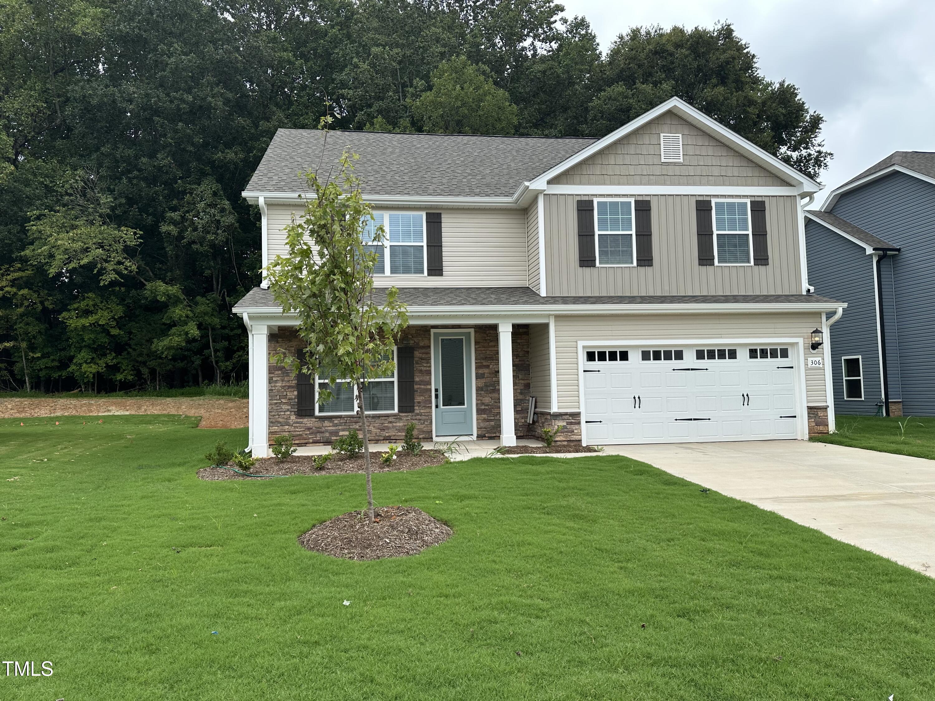 306 Shiloh Way Mebane, NC 27302 - Photo 33 of 33 a front view of a house with a yard and garage