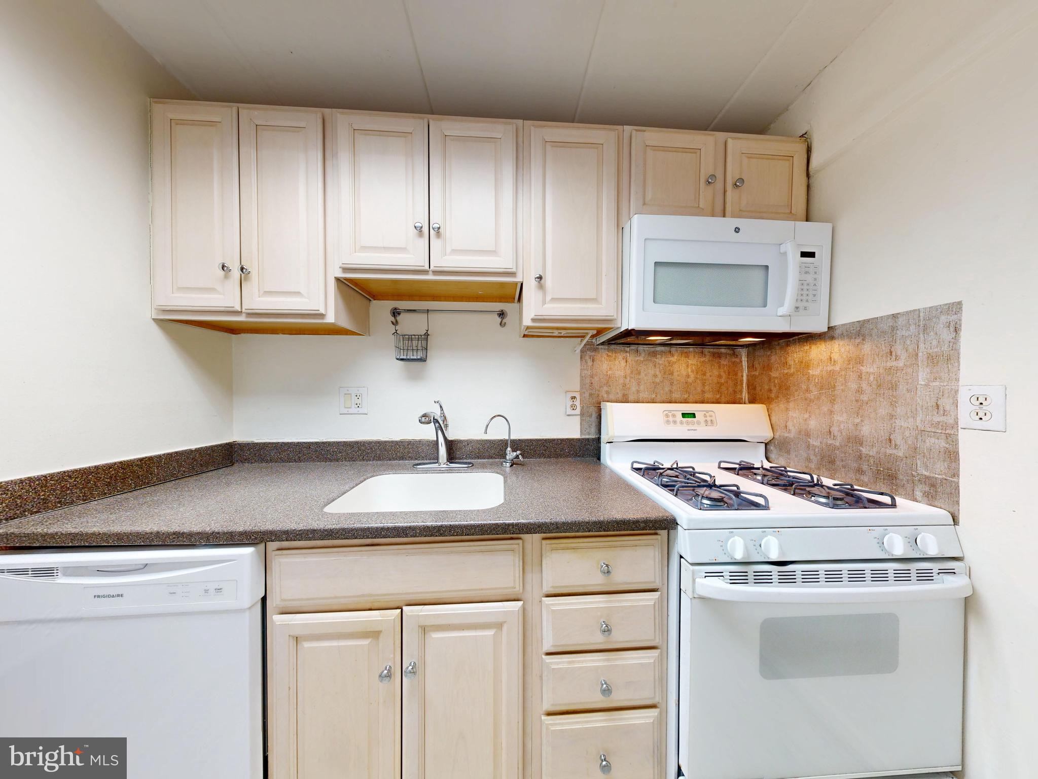 2629 Fort Farnsworth Road, Unit 276 Alexandria, VA 22303 - Photo 16 of 37 a kitchen with granite countertop a sink a stove and cabinets