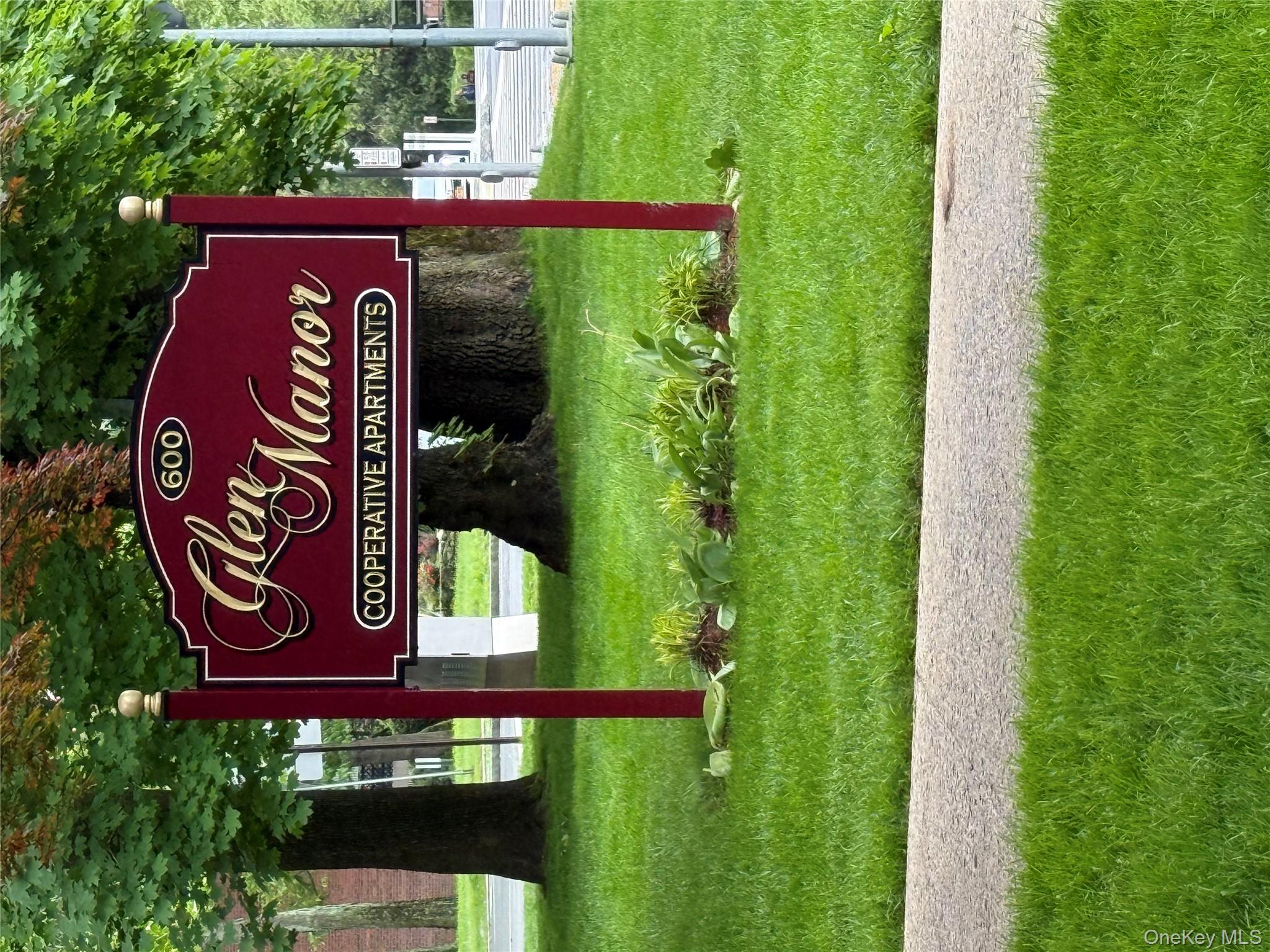 a sign that is sitting on the grass of the house