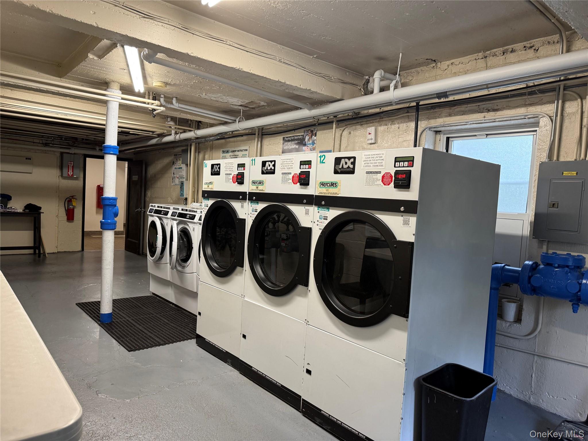 600 Pelham Road, Unit BUILDING B E New Rochelle, NY 10805 - Photo 6 of 7 a utility room with dryer washer and a view of living room