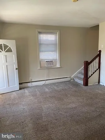 an empty room with windows and stairs