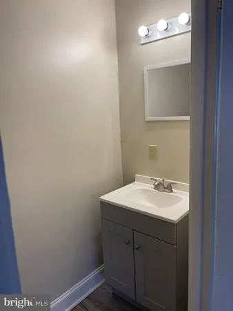 a bathroom with a sink vanity and a mirror