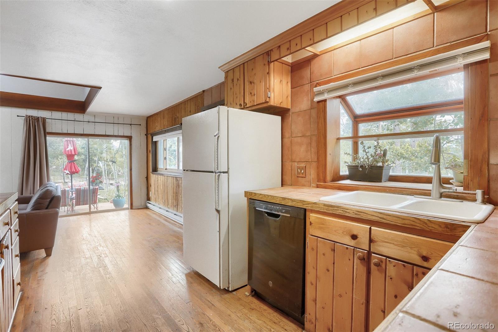 2 Debra Ann Road Golden, CO 80403 - Photo 12 of 41 a kitchen with a refrigerator a stove and a wooden floor