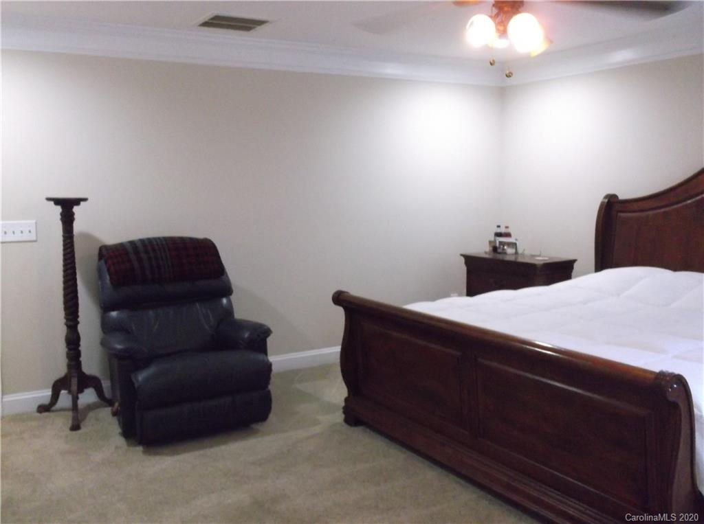 12450 Banks Road Mount Pleasant, NC 28124 - Photo 19 of 43 a room with a bed and a chair