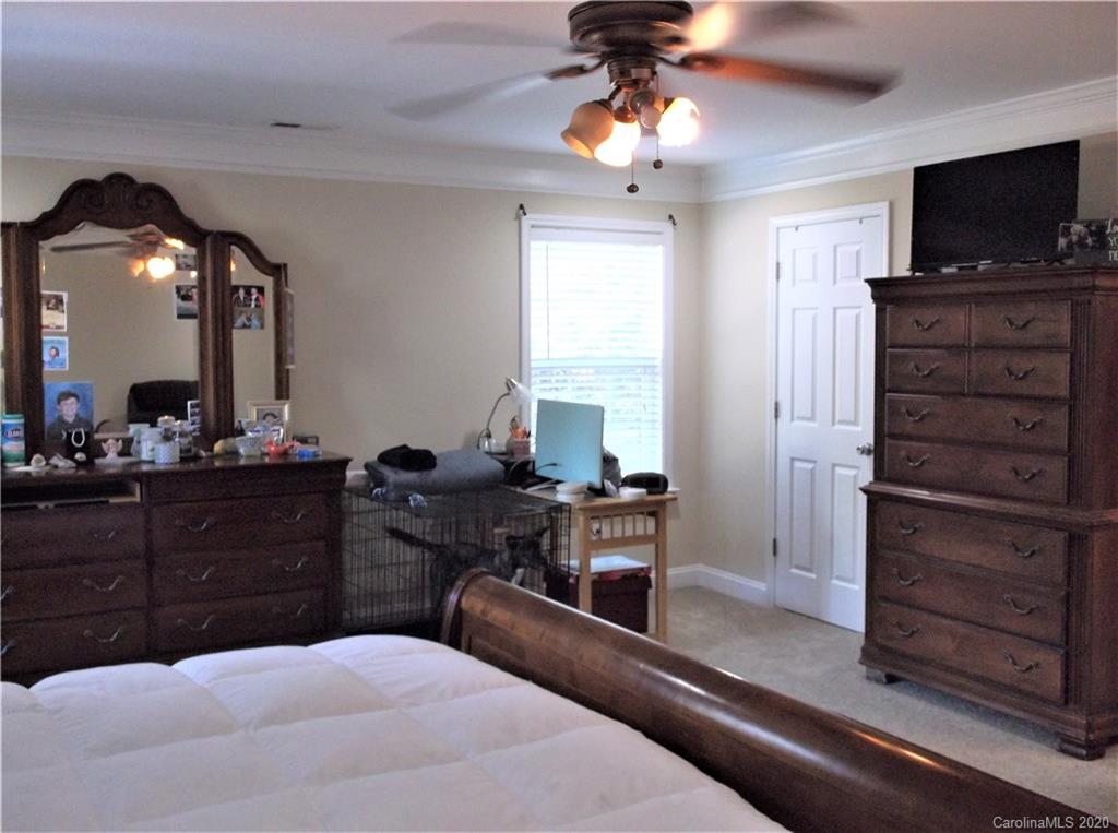 12450 Banks Road Mount Pleasant, NC 28124 - Photo 20 of 43 a bedroom with a bed and a flat screen tv