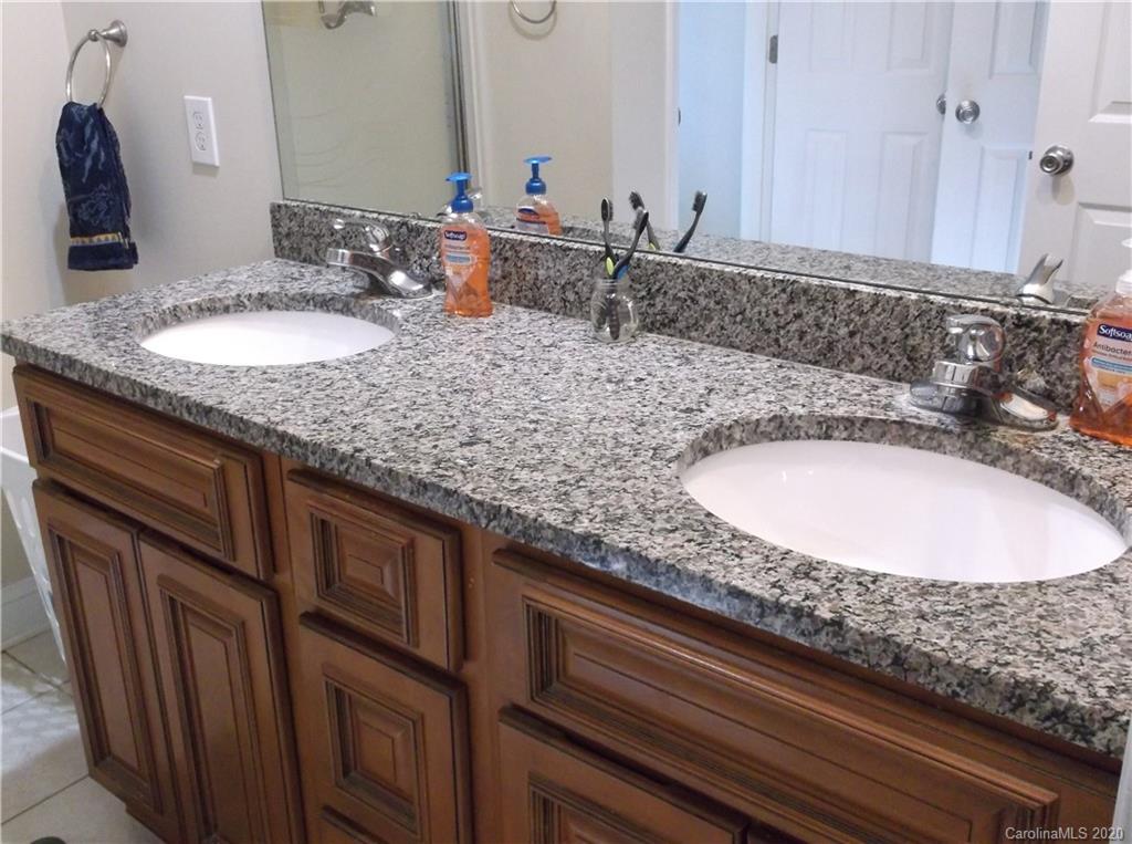 12450 Banks Road Mount Pleasant, NC 28124 - Photo 21 of 43 a bathroom with double vanity sinks and a mirror